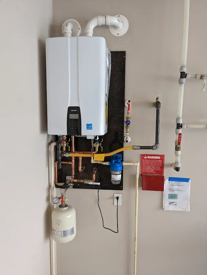 Professional plumber installing copper piping in a Chatfield home